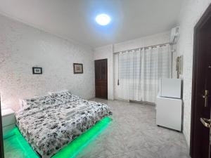 a bedroom with a bed and a refrigerator at Bianca B&B in Ardea