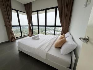 a bed in a room with large windows at Cream Nest Minimalist 2BR 4 pax Medini Legoland in Iskandar Puteri +12 photos