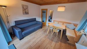 a living room with a couch and a table at Apartment Gastein 2 in Bad Gastein