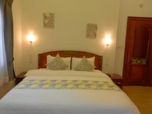 Postel nebo postele na pokoji v ubytování Eureka Villas Siem Reap