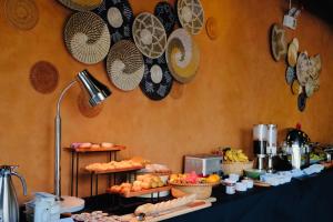a buffet with plates and food on a table at The City Boutique Hotel in Bien Hoa