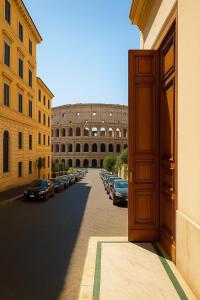 an open door to a street with parked cars at REALE COLOSSEO TREVI HOME - private garden in Rome +18 photos