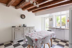a kitchen with a table and chairs in a room at maison Amboise in Limeray +14 photos