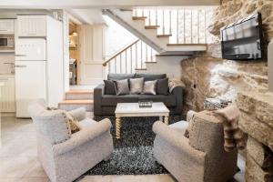a living room with two couches and a tv at Casa de Carmen in Corcubión
