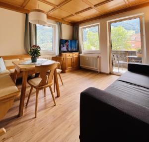 a room with a bed and a table and a tv at Apartment Gastein 2 in Bad Gastein