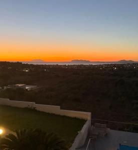 a sunset from the roof of a house at Villa Demirà - Chic Panoramic Rooms Marsala in Marsala