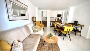 a living room with a couch and a dining room at Luxury Bahia Sea Views by Deihu Experiences in Los Cristianos