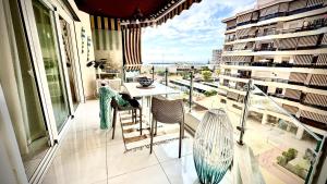 a balcony with a table and chairs on a balcony at Luxury Bahia Sea Views by Deihu Experiences in Los Cristianos