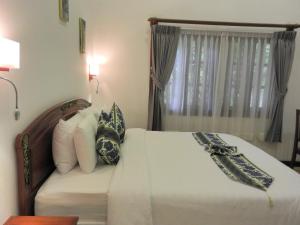 Postel nebo postele na pokoji v ubytování Eureka Villas Siem Reap