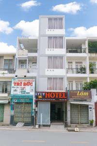 a white building with signs in front of it at Ly Ly Hotel in Ho Chi Minh City