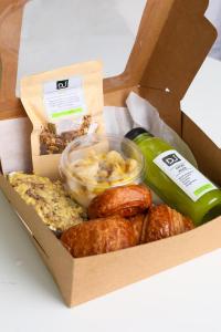 a box filled with different types of food at StayHere Casablanca - Maarif Lifestyle Suites in Casablanca +76 photos