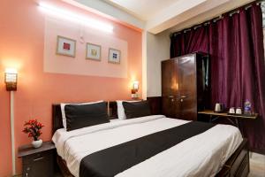 Postel nebo postele na pokoji v ubytování Super Hotel O Green Park Residency