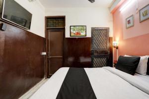 Postel nebo postele na pokoji v ubytování Super Hotel O Green Park Residency + 21 fotografií