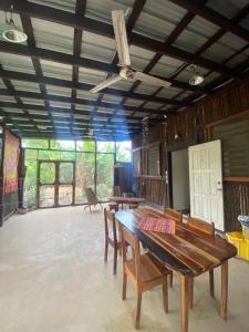 a dining room with a wooden table and chairs at Caribbean House in Sarteneja