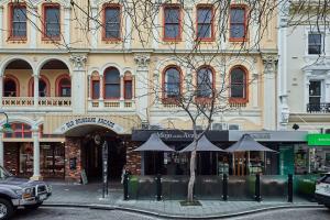 a building with umbrellas in front of a street at The Avenue in Launceston
