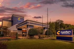 a confident inn and suites sign in front of a building at Comfort Inn & Suites Clemson - University Area in Clemson
