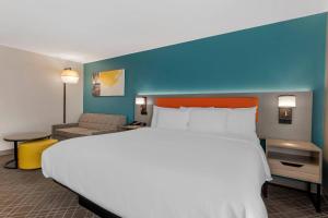 a large white bed in a hotel room at Comfort Inn & Suites Clemson - University Area in Clemson +28 photos