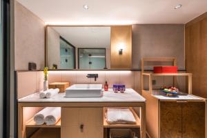 a bathroom with a sink and a mirror at Manxin Hotel Beijing Lama Temple in Beijing