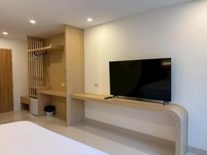 a living room with a tv on a wall at Luna Resident in Ban Bang Phai