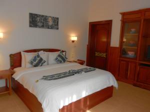Postel nebo postele na pokoji v ubytování Eureka Villas Siem Reap