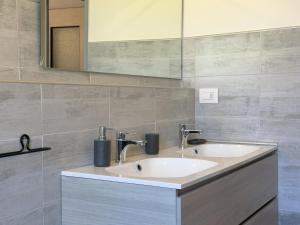 a bathroom with two sinks and a mirror at Quiet Home in Val Brona in Valbrona +22 photos