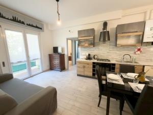 a kitchen with a table and a dining room at Quiet Home in Val Brona in Valbrona