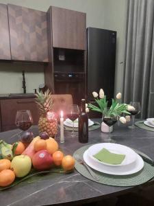 a table with plates of fruit and candles on it at Perla Toscana - Relax a 30 km da Firenze in Podere Modello