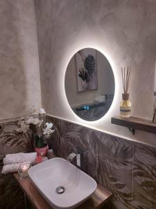 a bathroom with a white sink and a mirror at Perla Toscana - Relax a 30 km da Firenze in Podere Modello