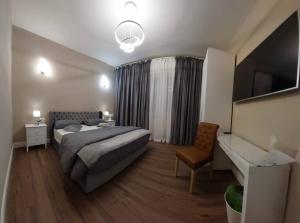 a bedroom with a bed and a desk and a television at Perla Toscana - Relax a 30 km da Firenze in Podere Modello