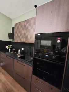 a kitchen with a black oven and a microwave at Perla Toscana - Relax a 30 km da Firenze in Podere Modello +43 photos