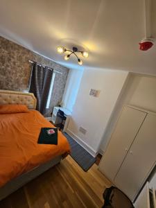 ロンドンにあるSky homesのベッドと天井扇風機のある寝室