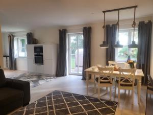 a kitchen and living room with a table and chairs at Böhler Haubarg Böhler Stuv 7 in Böhl