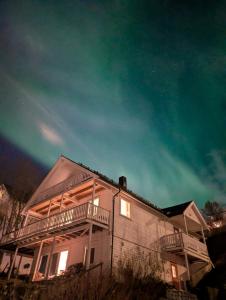 a house with a balcony on the side of it at Near Downtown - Large Beds - Free Parking in Tromsø