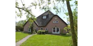 a red brick house with a black roof at Böhler Haubarg Böhler Stuv 7 in Böhl