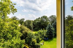 a view of a park from a window at WelcomeCologne Apartments in Cologne