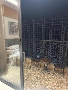 a sliding glass door with two chairs and a table at Amara heaven in Lucknow