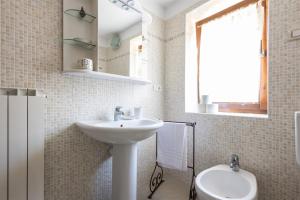 a white bathroom with a sink and a toilet at IseoLakeRental - Chalet Giulia in Sovere +21 photos