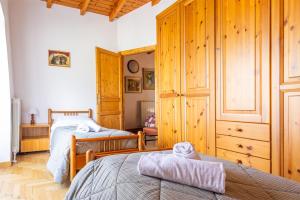 a bedroom with two beds and a wooden cabinet at IseoLakeRental - Chalet Giulia in Sovere