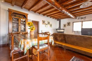 a dining room with a table and a television at IseoLakeRental - Chalet Giulia in Sovere