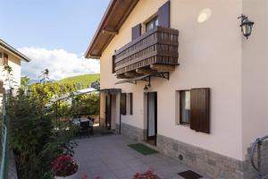 a house with a balcony and a patio at IseoLakeRental - Chalet Giulia in Sovere