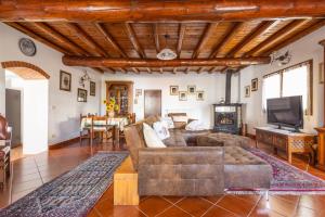 a living room with a couch and a tv at IseoLakeRental - Chalet Giulia in Sovere