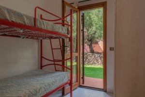 a room with two bunk beds and a sliding glass door at Holiday home in San Teodoro 26875 in San Teodoro