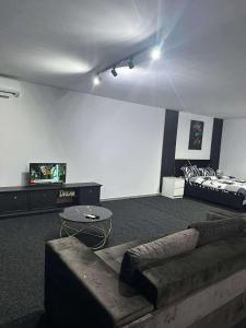 a living room with a couch and a bed at Home No 7 