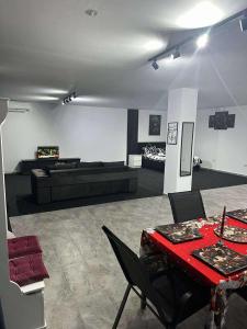 a living room with a red table and a couch at Home No 7 