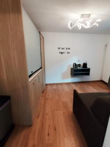 a living room with a couch and a wall with a window at B&B Berninapass in Poschiavo +22 photos