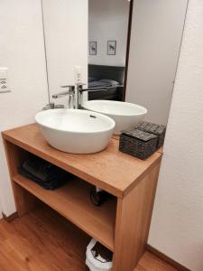 a bathroom with a white sink and a mirror at B&B Berninapass Poschiavo Panorama in Poschiavo +23 photos