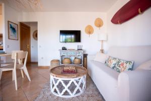 a living room with a couch and a table at Alma Ventura House - Majanicho in Majanicho