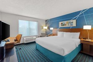 a hotel room with a large bed and a television at Comfort Inn & Suites Berea in Berea