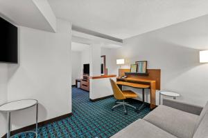a hotel room with a desk and a bed at Comfort Inn & Suites Berea in Berea