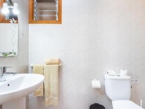 a white bathroom with a sink and a toilet at Live Salinas 3 in Caleta de Interián